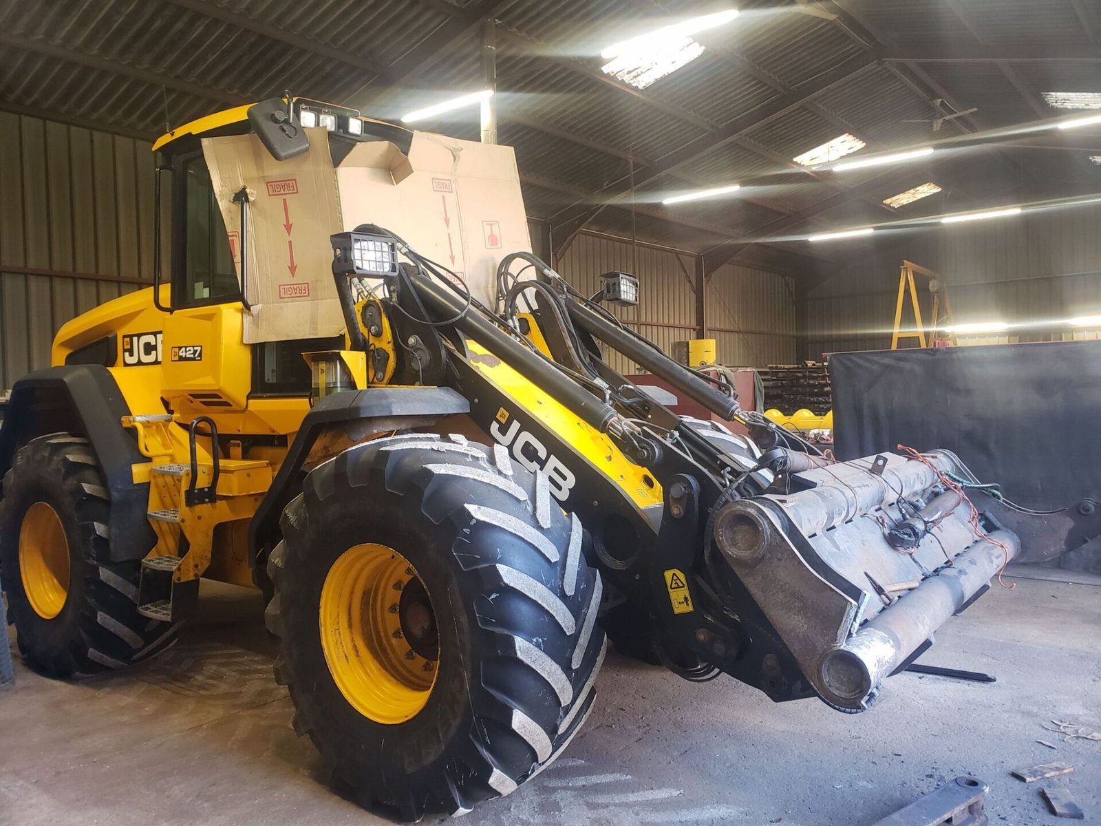 Remplacement bras sur godet à basculement